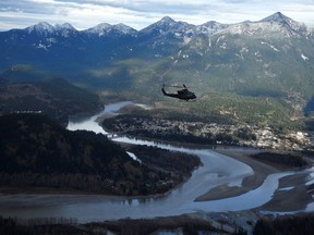 One of three Royal Canadian Air Force helicopters surveys the Fraser Valley after rainstorms lashed the western Canadian province of British Columbia, triggering landslides and floods, shutting highways, near Abbotsford, B.C., Sunday, Nov. 21, 2021. The B.C. government says it has finalized a deal with Washington state and several First Nations to work together on flood-risk mitigation and salmon habitat restoration for the Nooksak and Sumas watersheds on the Canada-U. S. border.