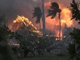 FILE - The hall of historic Waiola Church in Lahaina and nearby Lahaina Hongwanji Mission are engulfed in flames along Wainee Street on Aug. 8, 2023, in Lahaina, Hawaii. The death toll for the deadliest U.S. wildfire in more than a century has increased by one, to 99, after Maui County police found additional remains. The remains were recovered on Oct. 12 in Lahaina, police spokesperson Alana Pico said in an email Friday, Oct. 20, 2023.