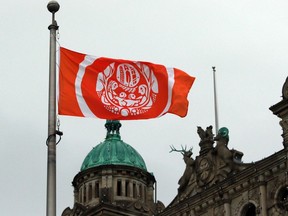 The Survivors' Flag hangs to honour Indigenous Peoples who were forced to attend residential schools, on the grounds of the legislature in Victoria, B.C.