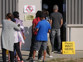 Voters line up to cast their ballots in Surrey, where a large proportion of the population is made up of immigrants.