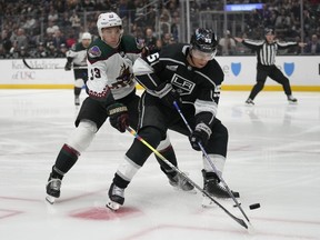 Arizona Coyotes defenceman Travis Dermott (33) defends against Los Angeles Kings centre Quinton Byfield (55) during the second period of an NHL hockey game Tuesday, Oct. 24, 2023, in Los Angeles.