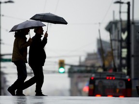 Pedestrians brave the wind and rain in Vancouver, BC. November 12, 2015.