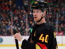 Elias Pettersson of the Vancouver Canucks checks his stick during their NHL game against the Calgary Flames at Rogers Arena, April 8, 2023.