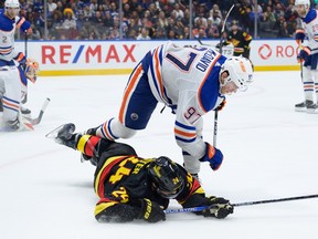 Pius Suter is knocked down by Connor McDavid during the third period at Rogers Arena on Nov. 6.