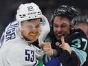 Feisty Canucks centre Teddy Blueger fights Yanni Gourde of the Kraken at Climate Pledge Arena in Seattle on Nov. 24.