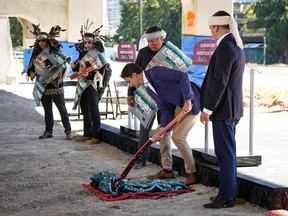 Prime Minister Justin Trudeau takes part in a groundbreaking ceremony with Squamish Nation councillors Wilson Williams, back centre, and Khelsilem, right, at the First Nation's Senakw housing development site, in Vancouver, on Sept. 6, 2022.