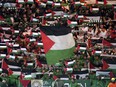 Celtic fans in the stands wave Palestinian flags ahead of the Champions League Group E match between Celtic Glasgow and Atletico Madrid on Oct. 25.