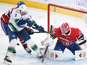 Vancouver Canucks' J.T. Miller (9) moves in on Montreal Canadiens goaltender Jake Allen during the first period in Montreal on Sunday.