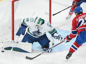 Vancouver Canucks goaltender Casey DeSmith stops Montreal Canadiens' Juraj Slafkovsky during the first period in Montreal on Sunday.