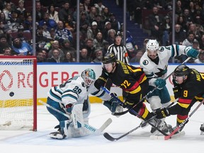 Vancouver Canucks' J.T. Miller (9) scores against San Jose Sharks goalie MacKenzie Blackwood (29) as Kyle Burroughs (4) checks Vancouver's Anthony Beauvillier (72) and San Jose's Tomas Hertl (48) watches during the third period on Monday night at Rogers Arena.