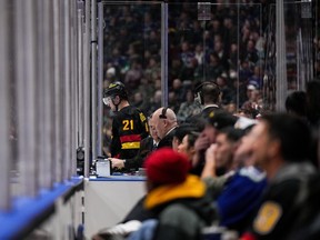 Vancouver Canucks' Nils Hoglander leaves the penalty box to go to the dressing room after receiving a match penalty during the second period on Monday night at Rogers Arena.