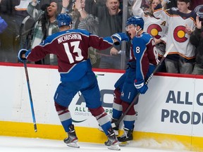 Colorado Avalanche right wing Valeri Nichushkin, left, and defenceman Cale Makar celebrate Makar's goal against the Vancouver Canucks during the third period on Wednesday night in Denver.