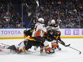 Anaheim Ducks' Alex Killorn (17) checks Vancouver Canucks' Dakota Joshua (81) during the first period on Tuesday at Rogers Arena.
