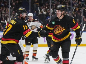 Vancouver Canucks' Brock Boeser, right, and Filip Hronek celebrate Boeser's goal against the Anaheim Ducks during the first period on Tuesday night at Rogers Arena
