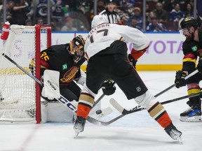 Vancouver Canucks goalie Thatcher Demko, back left, stops Anaheim Ducks' Alex Killorn during the second period.