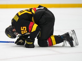 Ilya Mikheyev kneels on the ice after being struck by a shot during the third period