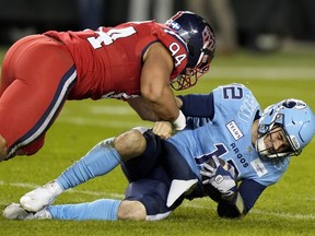 Montreal Alouettes defensive lineman Mustafa Johnson (94) tackles Toronto Argonauts quarterback Chad Kelly during the Eastern Final in Toronto, Saturday, Nov. 11, 2023.