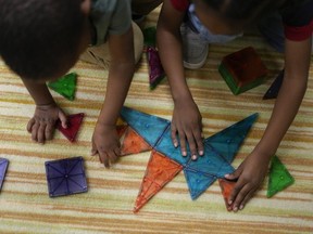 Children work on a puzzle