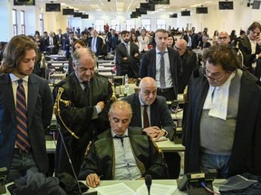 Officials listen as judges read the verdicts of a maxi-trial of hundreds of people accused of membership in Italy's 'ndrangheta organized crime syndicate, one of the world's most powerful, extensive and wealthy drug-trafficking groups, in Lamezia Terme, southern Italy, Monday, Nov. 20, 2023.
