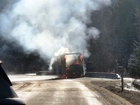 Police say a portion of the Coquihalla Connecter outside West Kelowna, B.C., is closed after a commercial truck carrying chemicals caught fire. The truck is seen on fire on Highway 97C in a Friday, Nov. 17, 2023, handout photo.