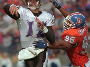 Denver Broncos defensive end Harold Hasselbach, right, pressures Baltimore Ravens quarterback Vinny Testaverde during an NFL football game in Denver, Sunday, Oct. 20, 1996.
