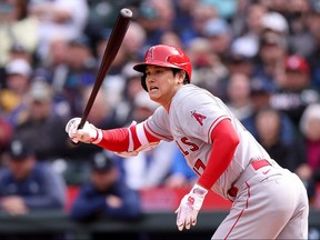 Shohei Ohtani of the Los Angeles Angels hits an RBI single during the seventh inning against the Seattle Mariners at T-Mobile Park on April 5, 2023 in Seattle, Wash.
