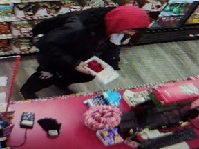 Surveillance image of a suspect allegedly stealing a poppy donation box from a Kelowna store on Nov. 6, 2023.
