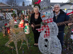 Andrea and Dan Bonneteau with some of the festive Christmas decorations outside their Surrey home.