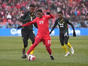 Canada's Jonathan David breaks away from Jamaica's Richard King (left) and Devon Williams during first half CONCACAF World Cup soccer qualifying action in Toronto on Sunday, March 27, 2022. David scored in Canada's 2-1 win over Jamaica on Saturday in Kingston, Jamaica.