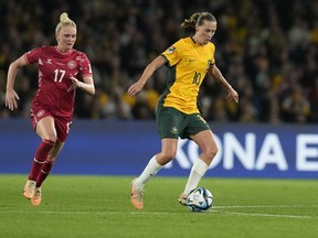 Australia's Emily Van Egmond, right, controls the ball during the Women's World Cup round of 16 soccer match between Australia and Denmark at Stadium Australia in Sydney, Australia, Monday, Aug. 7, 2023.