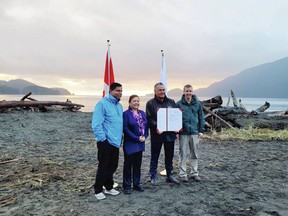 Gary Anandasangaree, minister of Crown-Indigenous relations; Ditidaht Chief Councillor Judi Thomas; Pacheedaht Chief Councillor Jeff Jones; and Dave Tovell, Acting Field Unit Superintendent, Coastal B.C., mark an agreement to return the use of ?A:?b?e:?s (Middle Beach) to the Pacheedaht First Nation near Port Renfrew on Wednesday, Nov. 15, 2023.