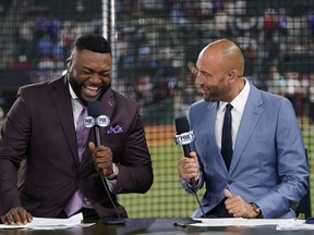 Former Boston Red Sox's David Ortiz laughs as he works with former New York Yankees' Derek Jeter works on set before Game 2 of the baseball World Series between the Arizona Diamondbacks and Texas Rangers Saturday, Oct. 28, 2023, in Arlington, Texas.