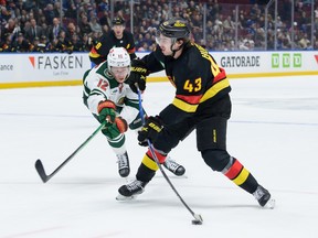 Quinn Hughes takes a shot against the Minnesota Wild on December 7 at Rogers Arena.