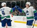 Brock Boeser gets a congrats from Conor Garland after scoring his 24th goal of the season against the Dallas Stars.