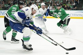 J.T. Miller #9 of the Vancouver Canucks skates for the puck during the second period against the Dallas Stars at American Airlines Center on December 21, 2023 in Dallas, Texas.