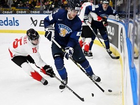 Canada's Matthew Poitras and Finland's Samu Bau vie for the puck during the Group A ice hockey match between Finland and Canada of the IIHF World Junior Championship in Gothenburg, Sweden on December 26, 2023.