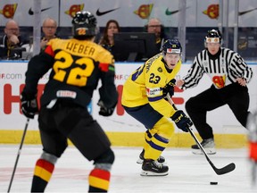 Germany's Jakob Weber (L) and Sweden's Jonathan Lekkerimaki fight for the puck during the Group A ice hockey match between Germany and Sweden of the IIHF World Junior Championship in Gothenburg, Sweden on December 28, 2023.