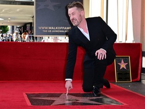 Macaulay Culkin gestures near his newly unveiled Hollywood Walk of Fame Star in Hollywood, Calif., on Dec. 1, 2023.