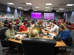 This image provided by the Department of Defense shows volunteers answering phones and emails from children around the globe during the annual NORAD Tracks Santa event on Peterson Air Force Base in Colorado Springs, Colo., Dec. 24, 2022.