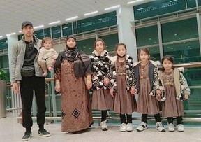 Gul Ahmadi, his wife Farida and their five girls pictured at the Islamabad International Airport before beginning their journey to Campbell River to start their new life.