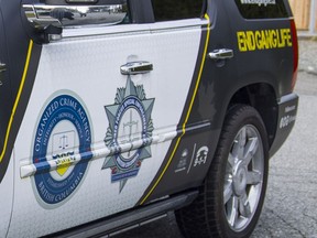 Logos of the Combined Forces Special Enforcement Unit of B.C. on a police vehicle.