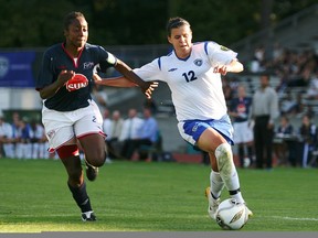 Christine Sinclair of the Vancouver Whitecaps keeps the ball away from defensive Robyn Gayle of the Ottawa Fury during the USL W- League playoffs first place match at Swanguard Stadium on Sunday. Vacouver took first place in the league after defeating Ottawa 3-0.