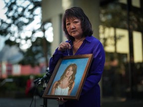 Carol Todd holds a photo of her late teenage daughter Amanda Todd, who died by suicide in 2012, and the necklace she was wearing in the school photo, outside B.C. Supreme Court after sentencing for the Dutch man who was accused of extorting and harassing her daughter, in New Westminster, B.C., on Friday, Oct. 14, 2022.