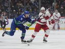Vancouver Canucks' Nikita Zadorov, left, and Carolina Hurricanes' Stefan Noesen vie for the puck during the first period of an NHL hockey game in Vancouver, on Saturday, December 9, 2023.