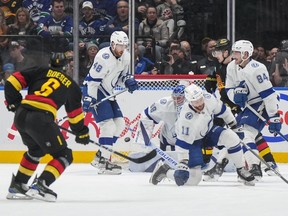 Brock Boeser (6) scores his second goal against Tampa Bay Lightning goalie Andrei Vasilevskiy (88) as Nicklaus Perbix (48), Tanner Jeannot (84) and Luke Glendening (11) defend during the second period on Tuesday night at Rogers Arena.