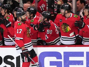 Chicago Blackhawks left wing Nick Foligno (17) celebrates with teammates after scoring his goal during the first period of an NHL hockey game against the Vancouver Canucks in Chicago, Sunday, Dec. 17, 2023.