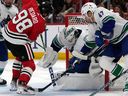 Canucks goaltender Thatcher Demko saves a shot by Chicago Blackhawks centre Connor Bedard during the second period on Sunday, Dec. 17, 2023.