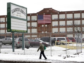 FILE - A man walks past the Remington Arms Company, Jan. 17, 2013, in Ilion, N.Y. The gun factory in upstate New York with a history stretching back to the 19th century is scheduled to close in March 2024, according to a letter from the company to union officials on Thursday, Nov. 30, 2023.