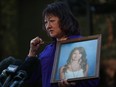 Carol Todd holds a photo of her late teenage daughter Amanda Todd, who died by suicide in 2012, and the necklace she was wearing in the school photo as she speaks outside B.C. Supreme Court after sentencing for the Dutch man who was accused of extorting and harassing her daughter, in New Westminster, B.C., on Friday, Oct. 14, 2022.