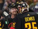 Vancouver Canucks centre Elias Pettersson congratulates goalie Thatcher Demko on a recent victory.